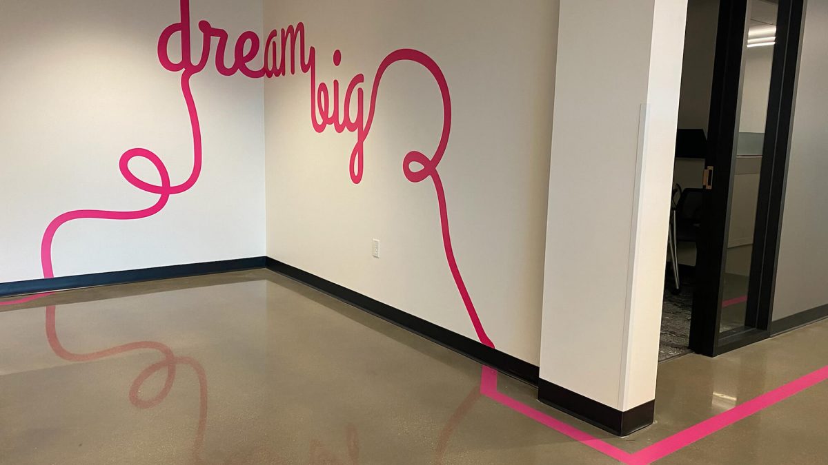 T-Mobile corporate office wall graphics, produced and installed by SuperGraphics. Showcases the message "dream big" in curly writing style, also extending off the wall and turning into a floor graphic.