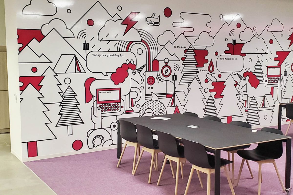 Illustrated T-Mobile wall mural with red, black, and white graphics in an office collaboration space.