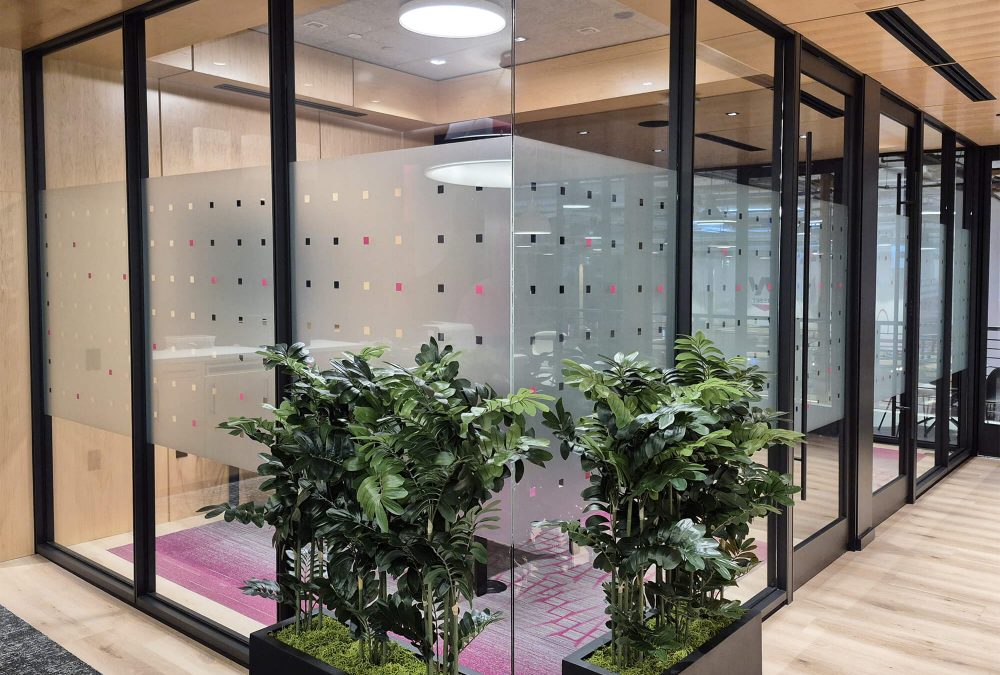 Corporate Privacy Window film, produced and installed by SuperGraphics. Showcases custom designs on dusted crystal window film, on corporate office glass wall.