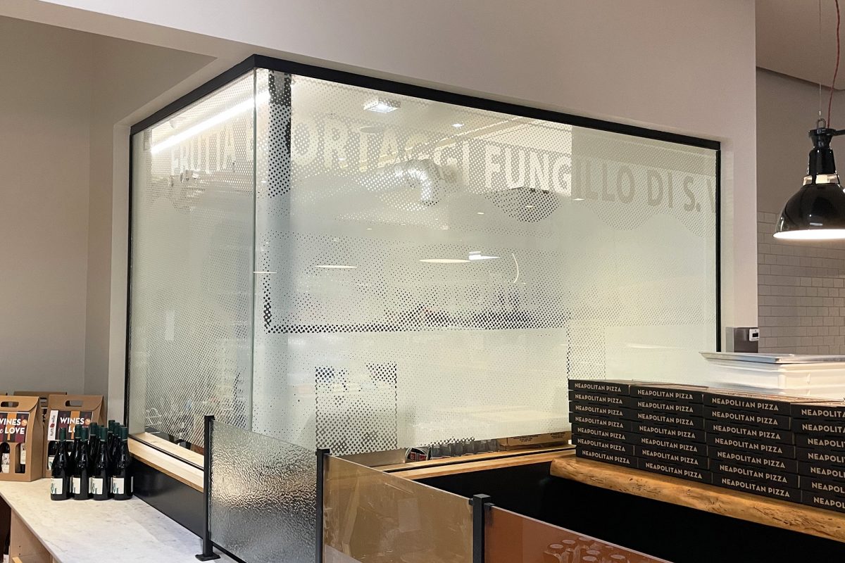 Tutta Bella privacy film, produced and installed by SuperGraphics. Privacy film showcases branded words within inverse dot design.