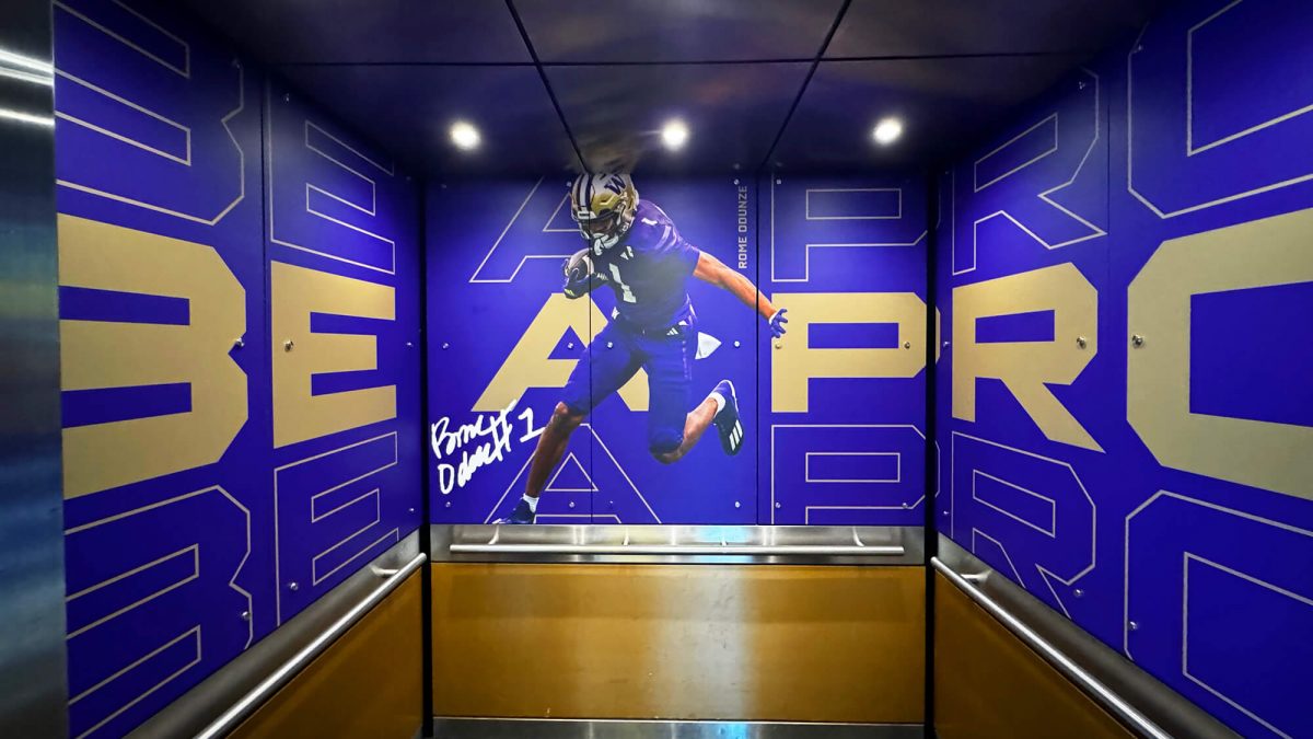 University of Washington elevator wall mural, produced and installed by SuperGraphics. Showcases photography of player along with branded graphics.