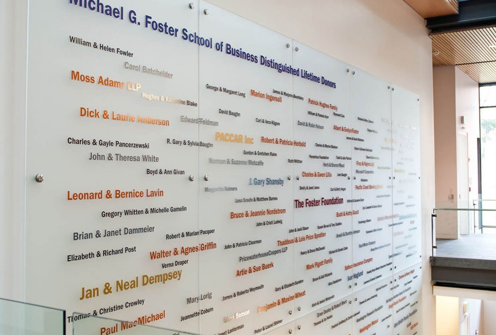 University of Washington Foster donor signage, produced and installed by SuperGraphics. Showcases various names on donors on white acrylic signage.