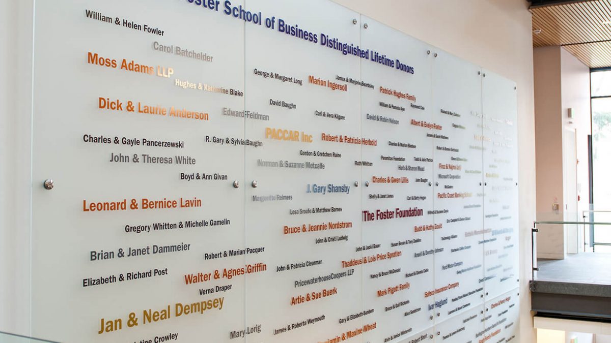 University of Washington Foster donor signage, produced and installed by SuperGraphics. Showcases various names on donors on white acrylic signage.