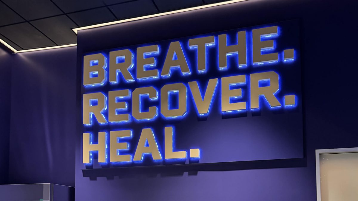 University of Washington Training Facility dimensional lettering, produced and installed by SuperGraphics. Features branded messaging: "Breathe. Recover. Heal."