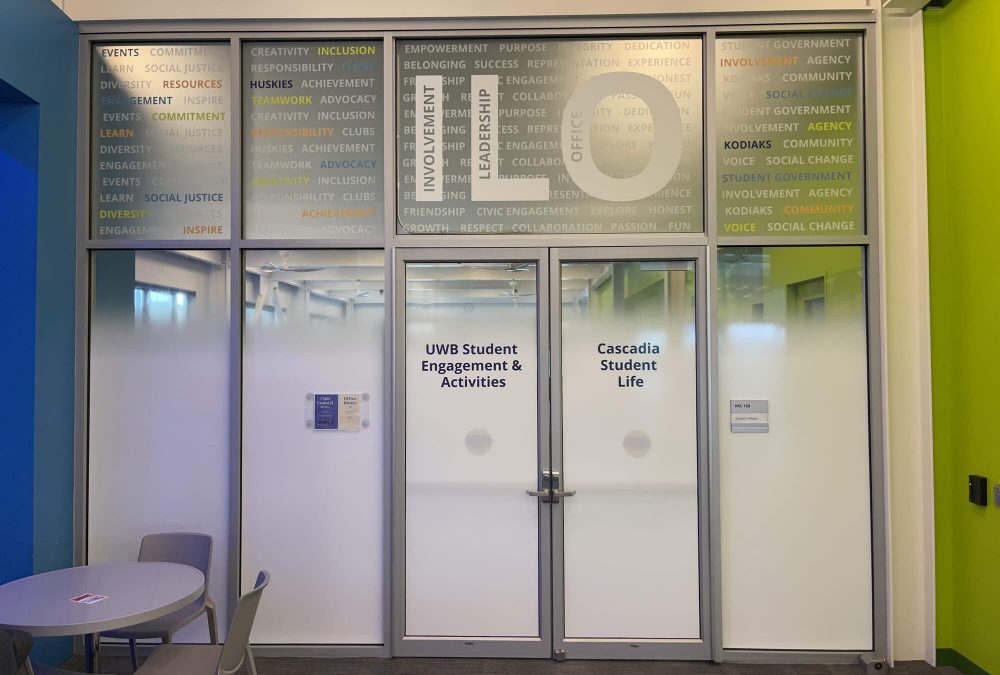 University of Washington Bothell Student Center window graphics, produced and installed by SuperGraphics. Features mission messaging and wayfinding on top of functional white privacy film.