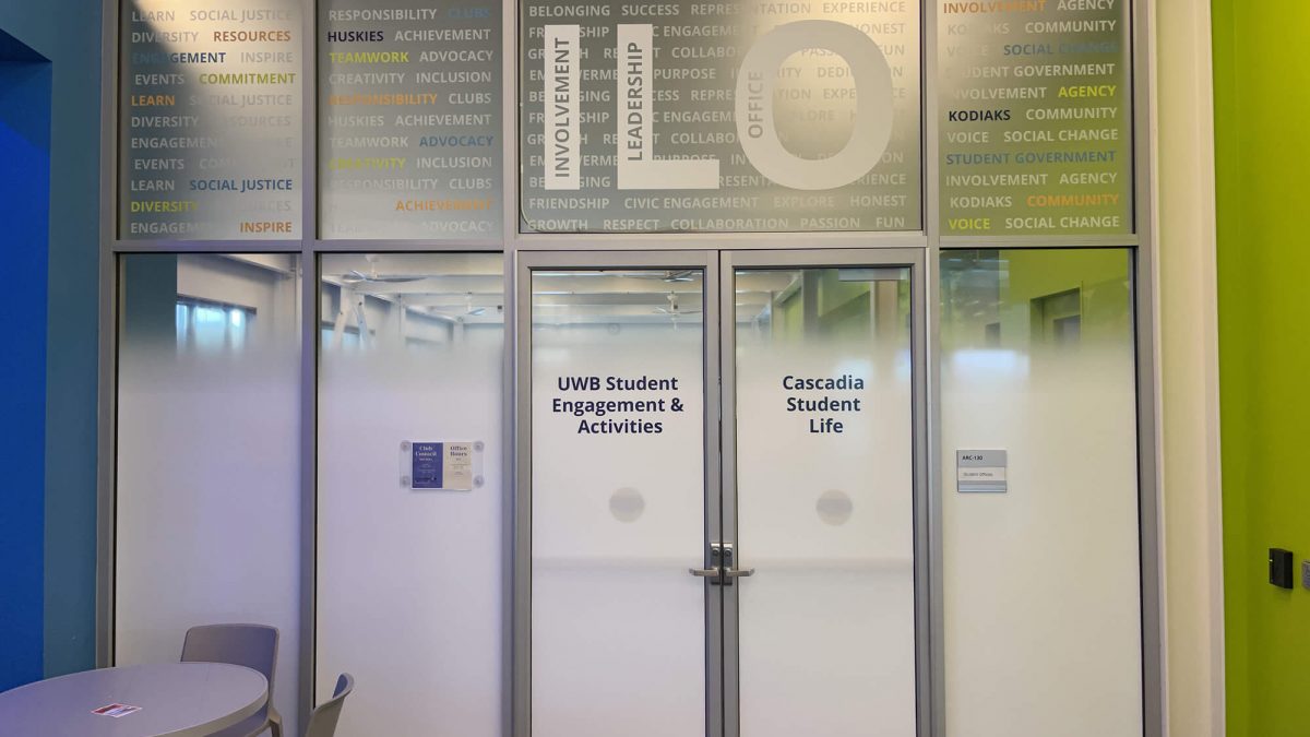 University of Washington Bothell Student Center window graphics, produced and installed by SuperGraphics. Features mission messaging and wayfinding on top of functional white privacy film.