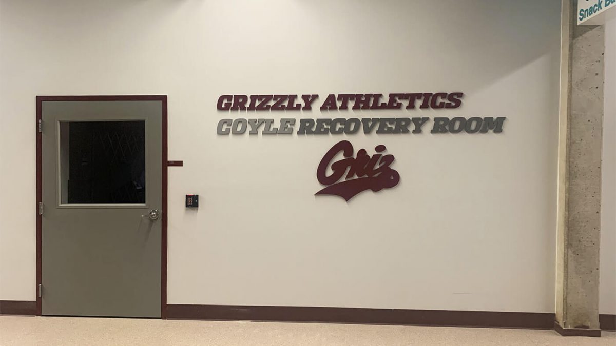 University of Montana Athletics recover room signage, produced and installed by SuperGraphics. Showcases branded dimensional lettering and logo for room.