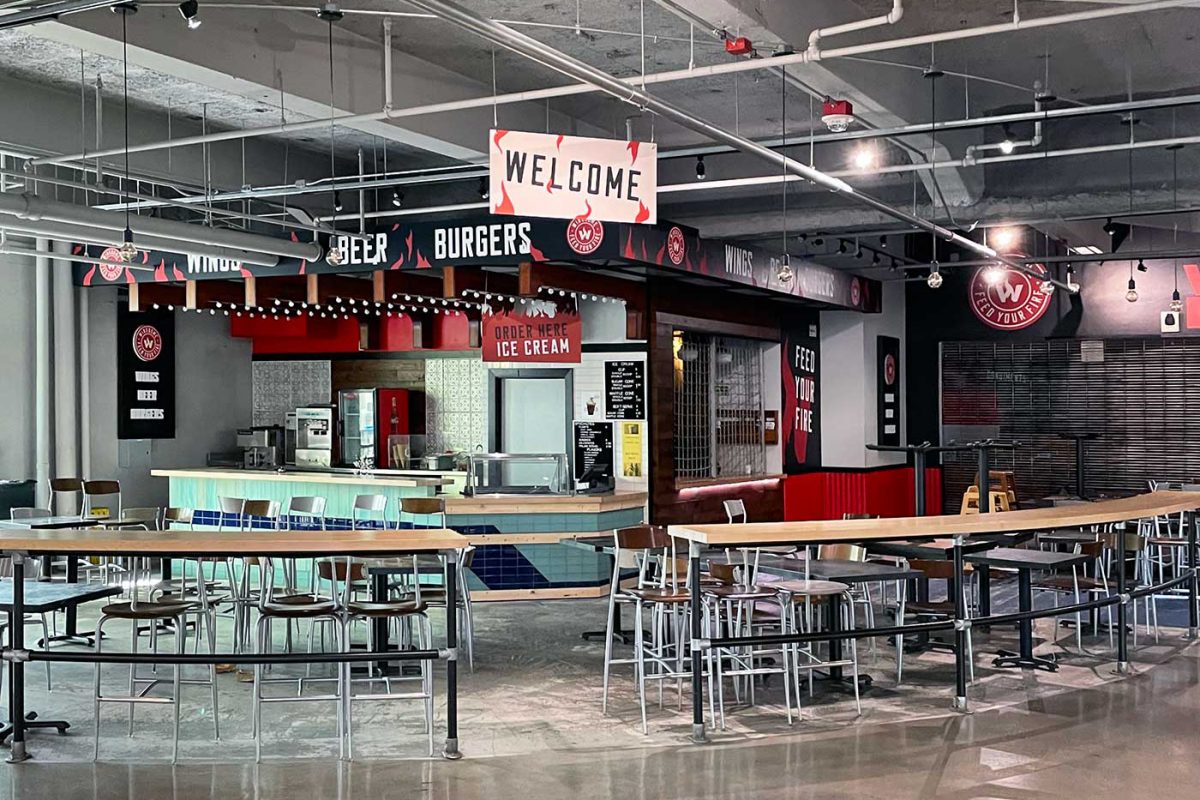 Wing Dome graphics, produced and installed by SuperGraphics. Features various printed wayfinding signage across restaurant storefront.